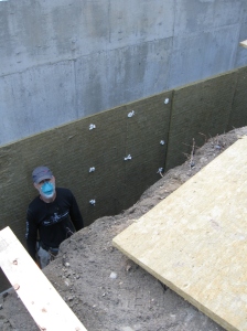 Tim ready for me to hand down a Roxul board. We wore long sleeves, and he wore a mask, because the Roxul boards gave off little irritating fibers...